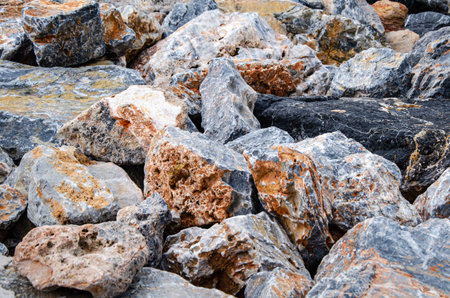 Close-up view of natural rocks and stones in diverse sizes and textures, showing their varied colors...