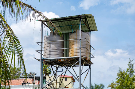 Elevated Water Tanks Under Metal Roof Against Blue Sky