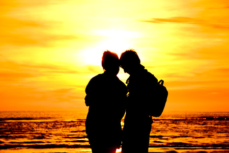 love on the beach at sunset.の写真素材
