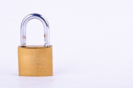 old brass padlock or master key on white background tool isolatedの写真素材