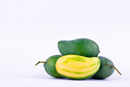 green  mango peeled and three fresh  green mangoes on white background healthy fruit food isolatedの写真素材