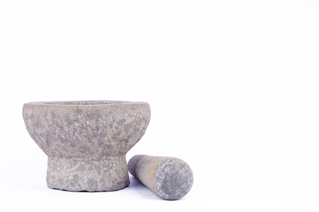 Old used granite stone mortar and pestle are Thai cooking tool on white background food isolatedの写真素材