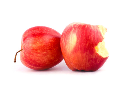 red apple with missing a bite on white background healthy apple fruit food isolatedの写真素材