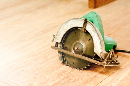 circular saw or power saw on wooden background tool woodcraft object isolatedの写真素材