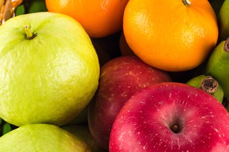Assortment of exotic fruits ( guava and orange and red apple )on  background fruit health foodの写真素材