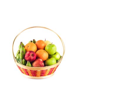 orange, Chinese pear, banana, red apple and green apple in wicker basket on white background fruit health food isolatedの写真素材