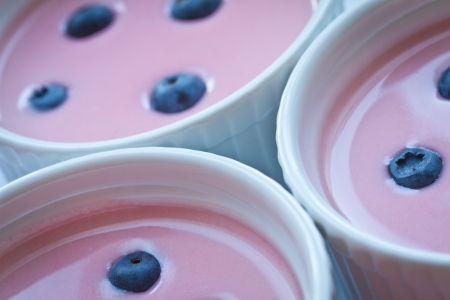 Strawberry panna cotta in the bowl with blueberriesの写真素材