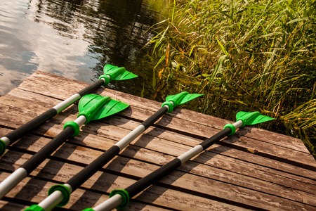 Green plastic oars lying on a pierの写真素材