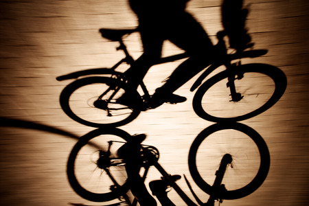 Shadow of the bicycle and cyclist vintage lookの写真素材
