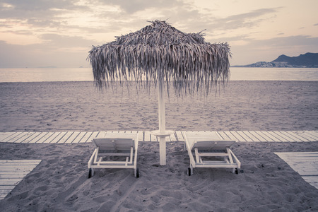 Hotel resort beach sea view with sunshades at sunset chillout color split toningの写真素材