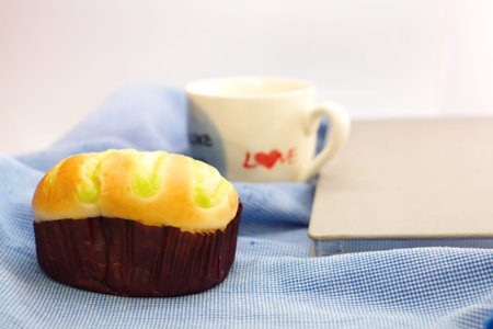 Bun and white coffee mug with word love on side