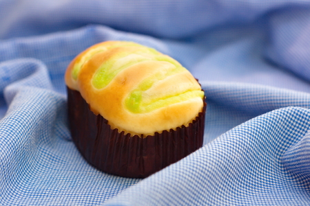 Bun with green custard fill on topの写真素材