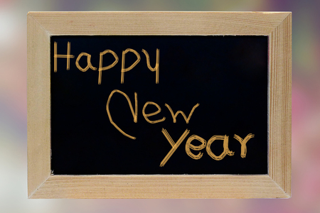 happy new year wood photo frame on pink blurred backgroundの写真素材