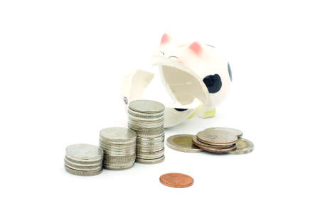 Thai stack coins with 
broken piggy bank on white background, financial concept photoの写真素材