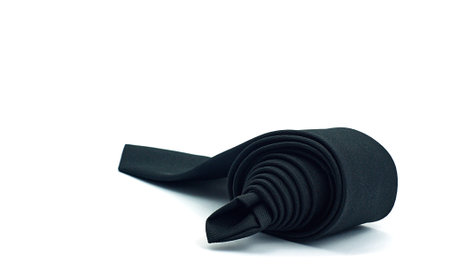 Black necktie on white background