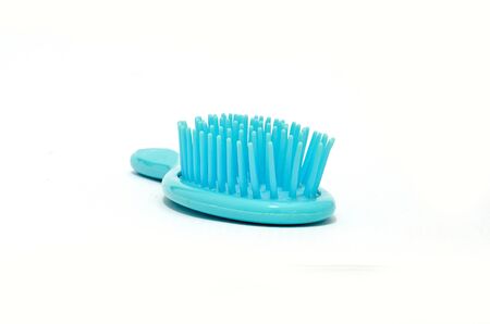 Blue plastic comb on white backgroundの写真素材