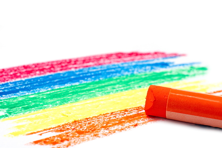 Rainbow color pattern and orange oil pastel on white backgroundの写真素材