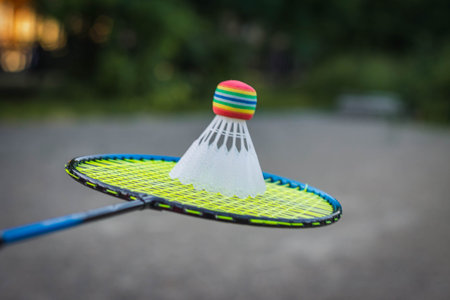 Rackets for badminton with an white shuttlecockon gravel crushed stone