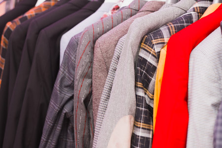 Mens clothing stores. Mens outerwear weighs on a hanger in the store. How to dress a man in 2020....