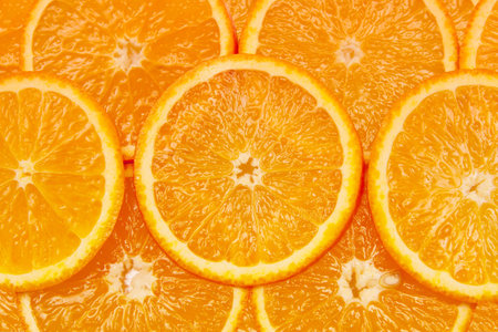 bright orange background from slices of juicy oranges