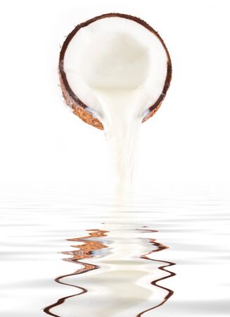 Coconut with coconut milk splash.isolated on a white backgroundの写真素材