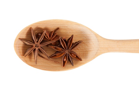 Star anise on a wooden spoon. isolated on a white backgroundの写真素材