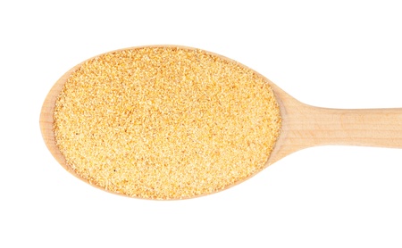 Dry ground garlic on a wooden spoon. isolated on a white backgroundの写真素材