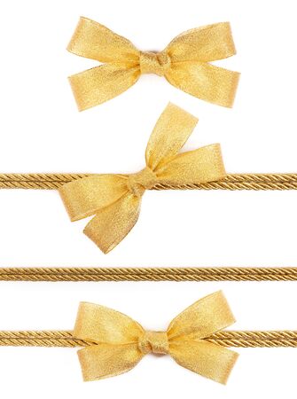 Gold bow on the ribbon isolated on white backgroundの写真素材