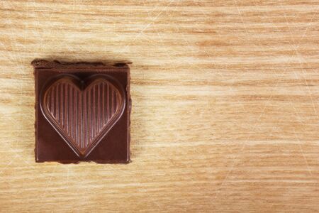 Chocolate heart on wooden textureの写真素材