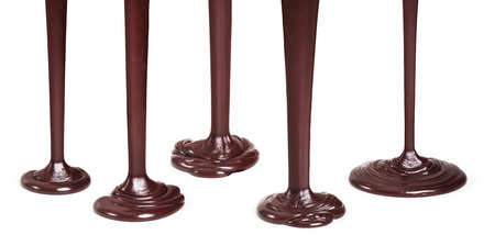Flowing dark chocolate isolated on white backgroundの写真素材