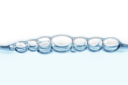 Oxygen bubbles in clear blue water, close-up. Mineral water. Water enriched with oxygen.の写真素材