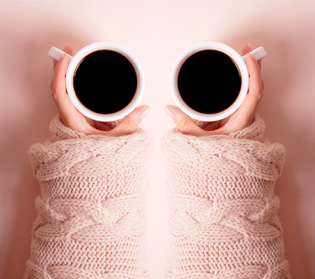 Woman with a cup of fragrant coffee in her hands on a cool day. Black warm coffee in cold weather. View from above.の写真素材
