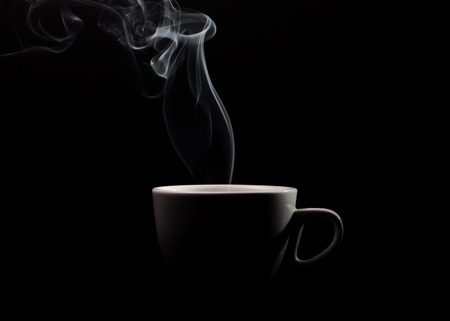 Fragrant coffee on a black background for your advertising. Smoke from hot coffee.の写真素材