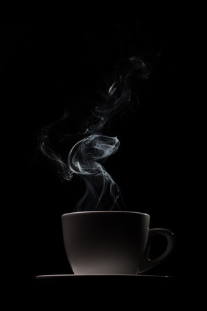 Fragrant coffee on a black background for your advertising. Smoke from hot coffee.の写真素材