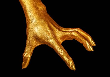 Hand gesture. Hand in gold paint, shiny, metallic. Isolated on black background.の写真素材