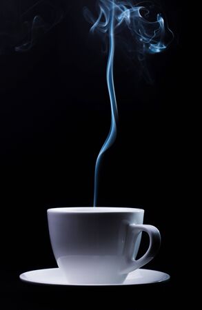 Fragrant coffee on a black background for your advertising. Smoke from hot coffee.の写真素材