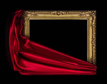 The wooden frame for the picture is covered with a silk red cloth isolated on a blackの写真素材