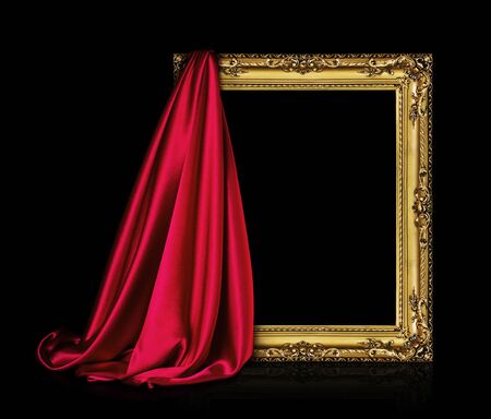 The wooden frame for the picture is covered with a silk red cloth isolated on a blackの写真素材