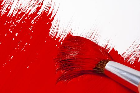 Drawing in red paints on white paper.の写真素材