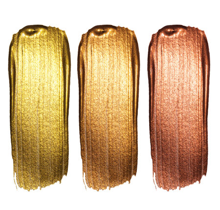 Creative brushstrokes of gold paint isolated on a white background. Gold paint texture.Acrylic gold...