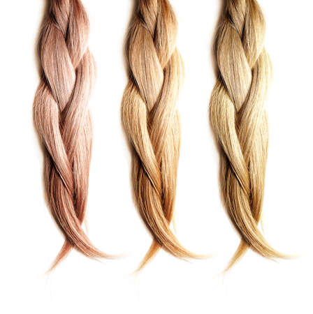 Healthy, shiny hair is braided on a white background. Hair samples of different shades.の写真素材