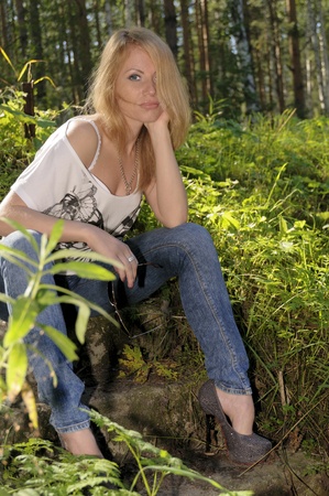 Outdoor closeup fashion portrait of young pretty woman in summer forestの写真素材