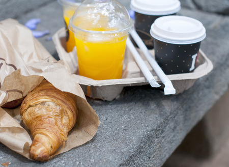 Croissant breakfast with coffee and orange juice to take awayの写真素材