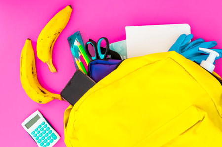 Yellow backpack full of school must-have tools also with face mask, hydro alcoholic gel and latex...