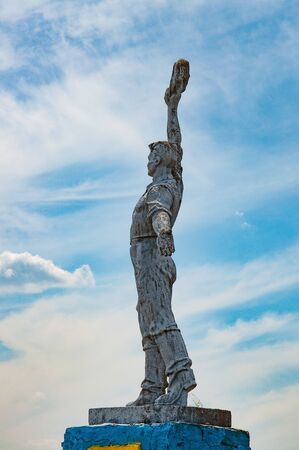 Soviet art worker statue with sky background. Social realism monument in Odessa countryside of Ukraineの写真素材