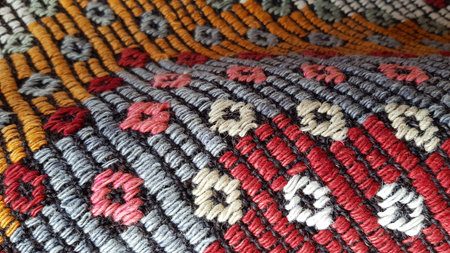 Folds of folk craft weave fabric with textured rhombus pattern closeup. Turkish ornamental carpet...