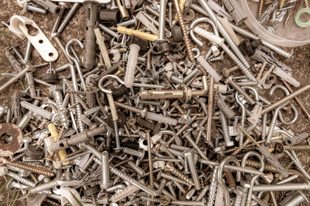 Grunge assorted metalware bolts and nuts flat lay. Work tools closeup. Abstract industrial...