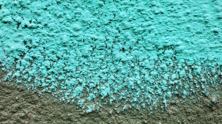 Turquoise blue painted wall surface closeup. Grunge texture background with spotted pattern and copy spaceの写真素材