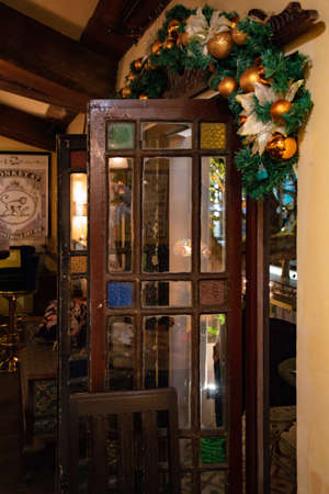 Vintage interior with opened old wooden door and traditional Christmas decorations. Shanghai, China, 12 05 2019のeditorial素材