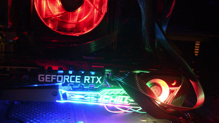 Closeup inside gaming PC tower with NVidia GeForce RTX 3080 graphics card. Vibrant colorful...